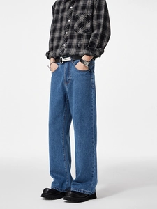 Men's loose fit baggy blue denim jeans with a wide leg and minimalist cityboy aesthetic