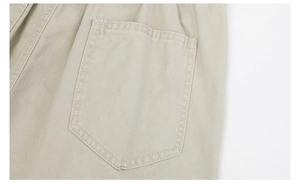Detailed close-up of pocket stitching on light khaki twill cotton casual trousers