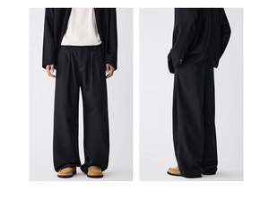 Macro detail of high-waisted pleated wide-leg trousers with vertical texture and drape