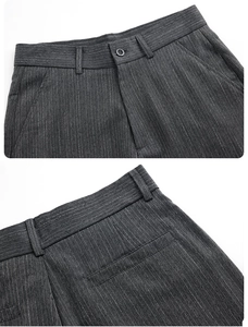 Detail of grey striped trouser waist featuring button closure and back welt pocket