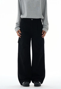 Detailed texture of black cotton twill utility pants with large flap side pockets