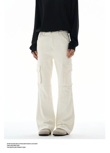 Detailed close-up of cream cargo flared pants showing seam lines and side patch pockets