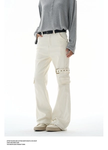 Detail of off-white cargo jeans featuring a metal buckle strap and multi-pocket design