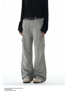 Detailed view of grey baggy cargo pants with side pockets and cotton twill texture