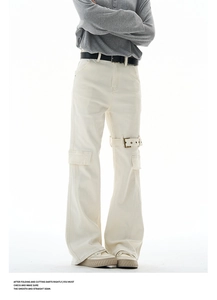 Detail of cream cargo pants featuring side utility pocket and adjustable metal buckle strap