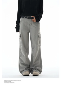 Close-up of baggy cargo pants with stitching details and flap pockets on washed fabric