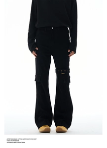Close-up of black cargo pants featuring metallic eyelet straps and multi-pocket design