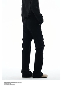 Detail view of the side cargo pockets and rear pocket stitching on black cargo pants