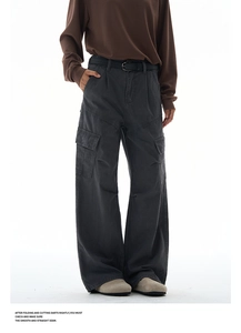 Detail of dark grey wide-leg cargo pants featuring side pockets and a black pin belt