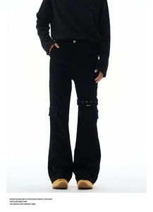 Detail of black Vibe style cargo jeans featuring metal buckle strap and utility pocket