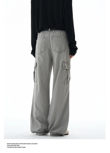 Rear view of baggy cotton twill cargo pants featuring large side pockets and relaxed fit