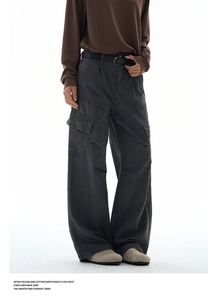 Detail view of charcoal gray cargo pants featuring multi-pocket design and pleated texture