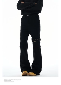 Macro shot of black flare cargo jeans featuring metal eyelets and strap pocket details