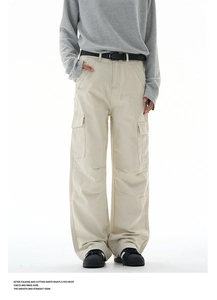 Detail view of baggy cargo pants with large side pockets and reinforced stitching