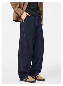 Close-up of dark blue wide-leg denim jeans with retro stitching and vintage wash