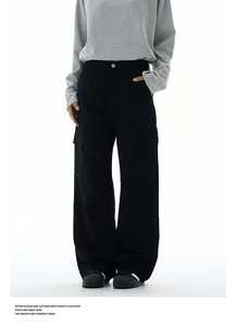 Close-up of high-waist cargo pants with large flap pockets and washed fabric texture