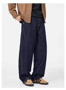 Detailed view of high-street wide-leg denim jeans with retro orange contrast stitching