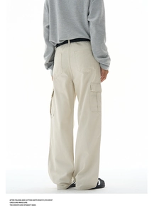 Detail view of khaki baggy cargo pants showing rear flap pockets and loose fit texture