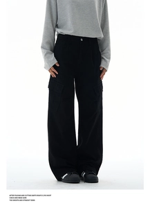 Detailed view of large flap cargo pockets on black wide-leg washed workwear trousers