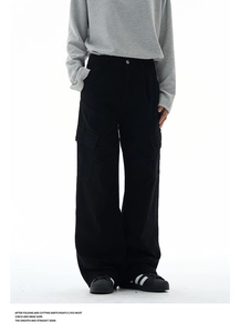 Detail view of large flap pockets and washed finish on black cargo pants