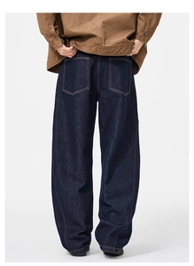 Rear view of deep blue wide-leg denim jeans with contrast orange stitching for men