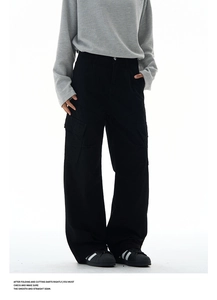 Detail of multi-pocket cargo pants with washed finish and relaxed wide-leg fit