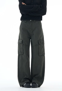 Close-up of deep army green cargo pants featuring large side flap pockets and durable cotton fabric