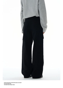 Rear view of loose-fit black cargo pants with multiple pockets and pleated details