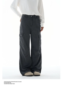 Detail view of charcoal grey baggy cargo pants with large flap pockets and wide leg cut