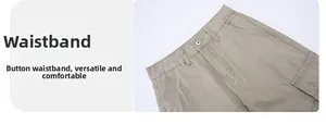 Detail view of khaki cotton cargo pants featuring button closure and waist belt loops