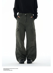 Detailed view of dark green baggy cargo pants with large side pockets and washed finish