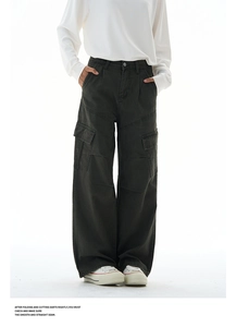 Detailed view of dark green cargo pants with large flap pockets and reinforced stitching