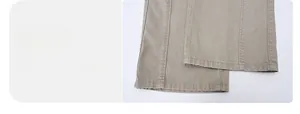 Detailed macro view of the double-stitched hem and durable khaki twill fabric on pants