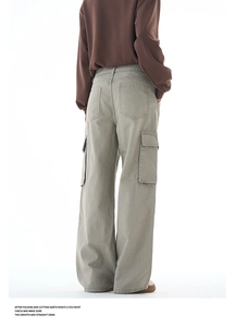 Rear view of sage green wide-leg cargo pants featuring large flap pockets and cotton fabric