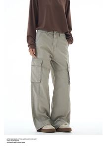 Detailed close-up of side cargo pocket on wide-leg cotton pants in olive green