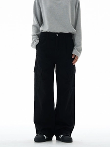 Washed black cargo pants with wide leg and utility pockets in street style look
