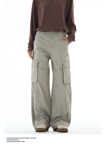 Detail of cargo pants showing side flap pockets and durable cotton fabric texture