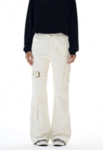 Detail of cream flared work pants showing side utility pockets and metal buckle strap