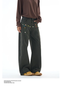 Detail of colorful floral embroidery on high-quality charcoal vintage wide-leg pants