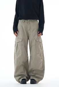 Close-up detail of oversized multi-pocket cargo pants with streetwear panel stitching