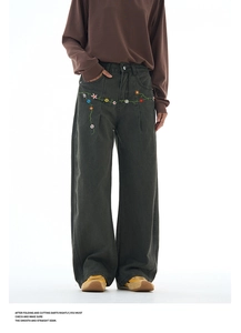 Detail of colorful floral embroidery on high-quality charcoal wide-leg denim pants