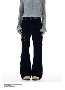 Detail of black wide-leg cargo pants with flap pockets and adjustable metal buckle belt