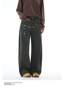 Detail of vintage flower embroidery on loose wide-leg pants in dark grey finish