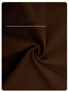 Detailed macro view of dark brown twill fabric texture with breathable weaving pattern