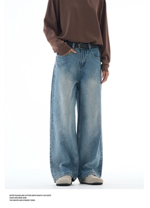 Detail shot of light blue washed wide-leg denim jeans with reinforced hem stitching