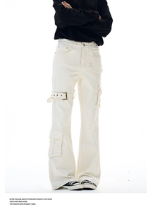 Close-up of ivory flared cargo pants featuring metal buckle detail and side utility pockets