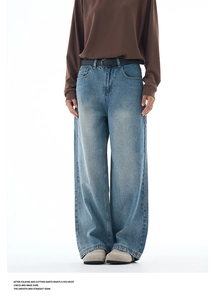 Detail view of light blue washed baggy jeans with vintage cat scratch pattern and retro fit