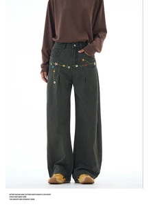 Detail of colorful floral embroidery on high-waisted wide-leg dark grey green jeans
