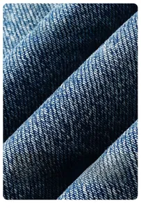 Macro shot of durable deep blue denim fabric with visible twill weave and stiff texture