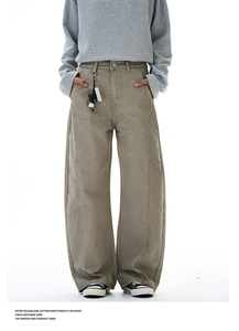Detail of vintage khaki cargo pants featuring curved stitching and wide-leg silhouette